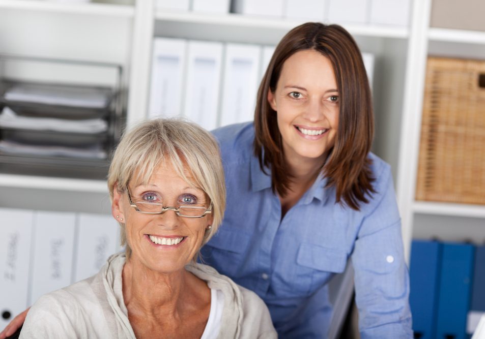 Older & younger woman at work