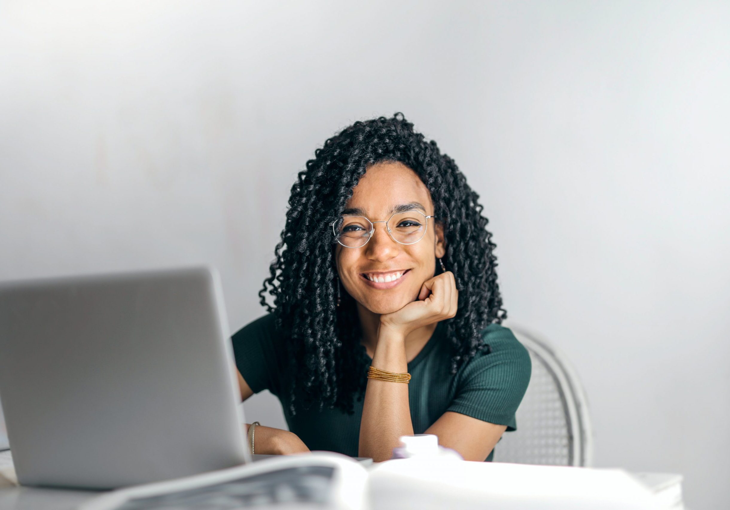 Young dark skinned woman on computer